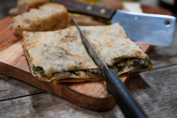 A traditional Fatayer (or Fitir), typical Lebanese pastry, stuffed with spinach and herbs, served...