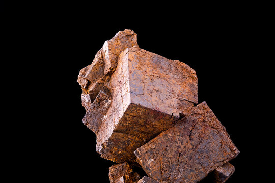 Limonite pseudomorph after Pyrite crystals isolated on black background. macro detail close-up rough raw unpolished semi-precious gemstone