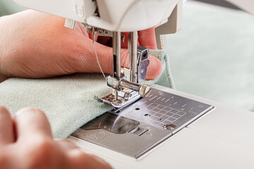 Sewing machine, stitching fabrics, needle in a round plan