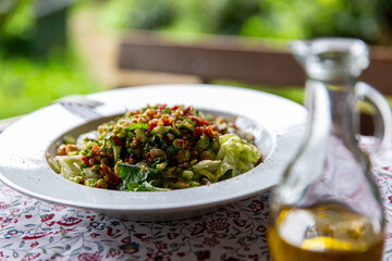 Healthy salad with olive oil and beautiful natural ambience