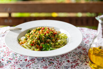 Healthy salad with olive oil and beautiful natural ambience