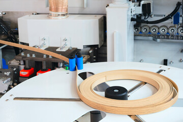 Machine tools for gluing edging onto furniture wood board, Edging PVC. Photo of cutter machine,...
