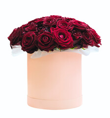 Beautiful bouquet of dark red roses flowers in round box and pink gift box on a white. Gift for...
