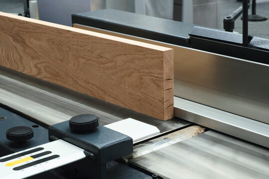 Wood boards on a woodworking machine in a modern furniture factory, woodworking industrial concept background