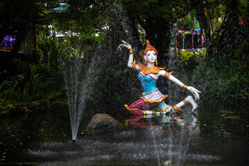 Beautiful statues in the jungle. Green leaves. Beautiful pond. Colorful statues.