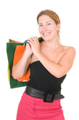 Full length portrait of a happy young woman with shopping bags over white background