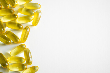 Close up fish oil supplement capsules isolated on white background. Pile of capsules Omega 3.