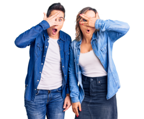 Couple of women wearing casual clothes peeking in shock covering face and eyes with hand, looking through fingers with embarrassed expression.