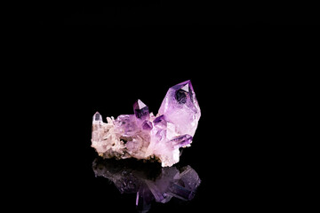 amethyst crystal isolated on black background. macro detail close-up rough raw unpolished...