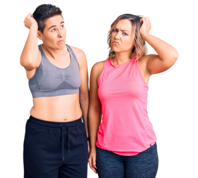 Couple of women wearing sportswear confuse and wondering about question. uncertain with doubt, thinking with hand on head. pensive concept.