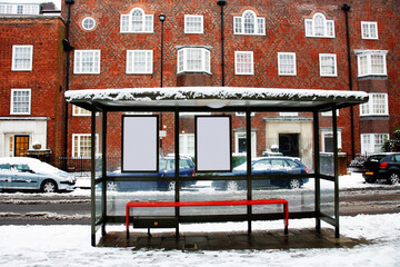 A Snow covered empty bus stop early morning nobody present. - 687532491