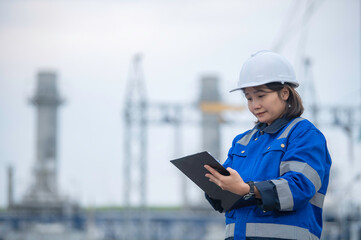 Asian woman petrochemical engineer working at oil and gas refinery plant industry factory,The people worker man engineer work control at power plant energy industry manufacturing