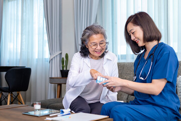 Senior woman get medical service visit from caregiver nurse at home while explaining on doses of...