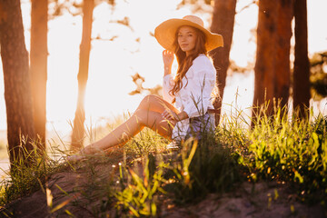 Young female swedish traveler woman in straw hat, white dress with buttons, looking at camera...