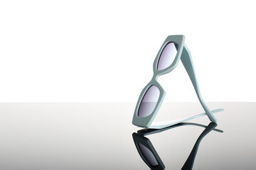 Fashionable sunglasses close-up on a dark gray glossy background. 