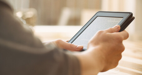 Woman reading an ebook on a reader with an e-ink display