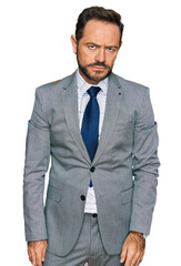 Fototapeta premium Middle age man wearing business clothes looking sleepy and tired, exhausted for fatigue and hangover, lazy eyes in the morning.