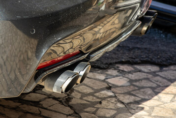 Sports car double exhaust black color close-up view