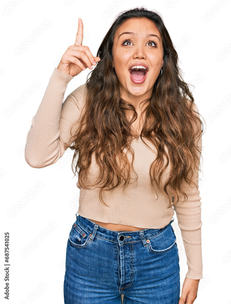 Sticker Young hispanic girl wearing casual clothes pointing finger up with successful idea. exited and happy. number one.