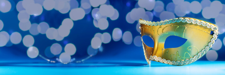 carnival mask on a magical blue background with bokeh, New Year and Christmas celebration,...