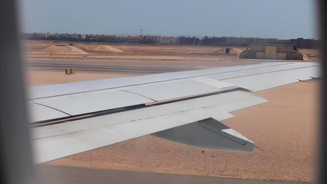 Airplane accelerating in Hurghada airport runway before taking off on a clear summer day in Egypt