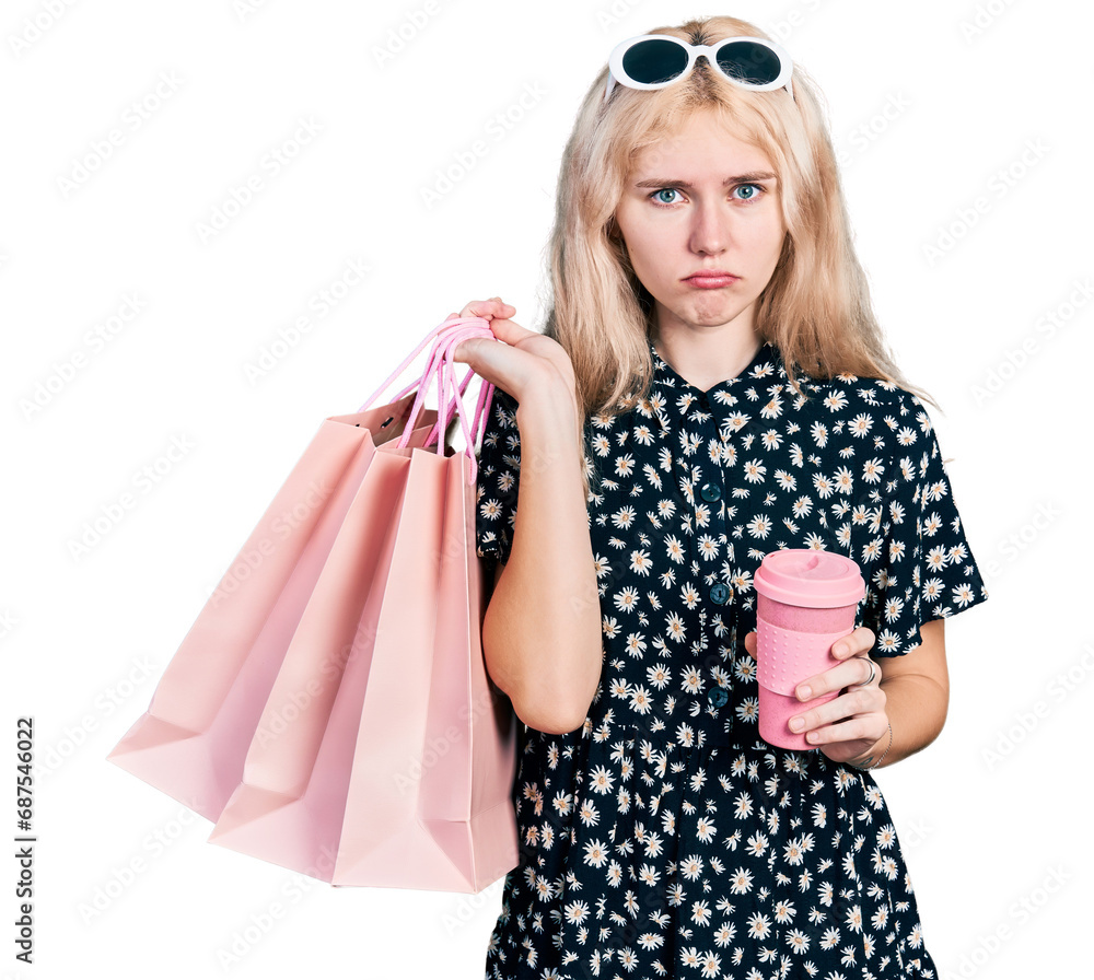 Canvas Prints young caucasian woman holding shopping bags and coffee depressed and worry for distress, crying angr