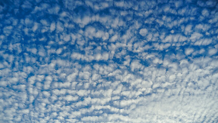 Blue sky and White cloud nature background. A daytime view of clouds and blue sky. Sparse cumulus...