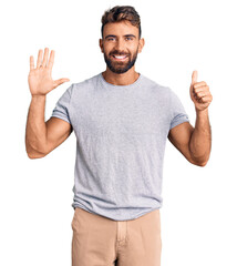 Fototapeta premium Young hispanic man wearing casual clothes showing and pointing up with fingers number six while smiling confident and happy.