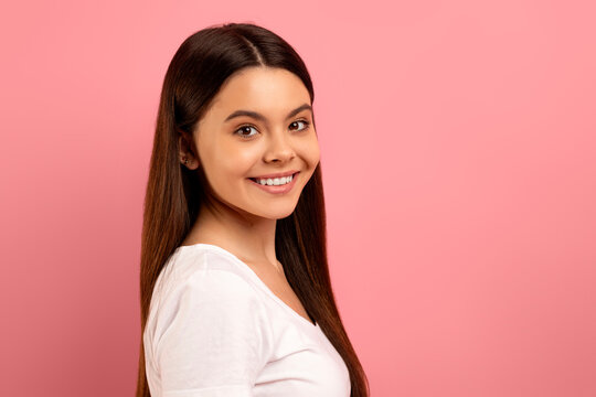 Attractive Teen Girl With Beautiful Smile Looking Over Her Shoulder At Camera