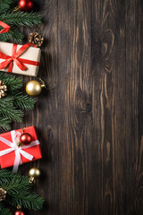 Christmas presents and holiday decorations on wooden background. Flat lay image.