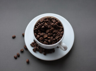 cup of coffee on a saucer on a gray background