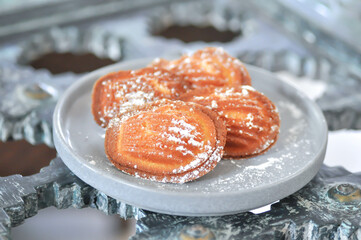 Madeleine, Madeleines or French bread with icing sugar topping
