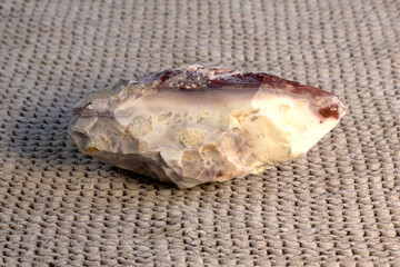 Pelitic Schist Rock on beige knitted fabric Background