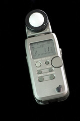 light meter against black background with readings displayed on screen 