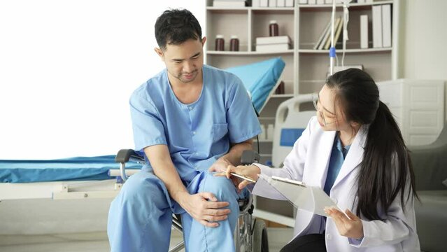 Nurse helping physical therapy of male patient at hospital, Asian female physical therapist working and helping protect patient's hands. Patient stretches muscles in clinic 4k