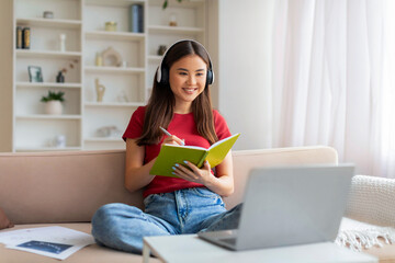 Young Asian Woman In Headset Study Online With Laptop From Home