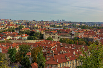 Fototapeta na wymiar Panoramic view of the city of Prague from the observation deck. Streets and architecture of the old city. Romantic town panorama, historical buildings, red roofs, churches.