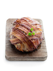 Italian bacon wrapped meatloaf on wooden board