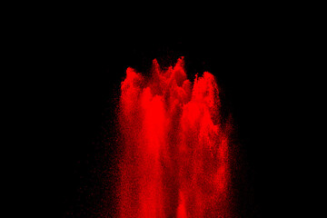 red powder explosion on black background. Colored cloud. Color dust explode. Paint Holi