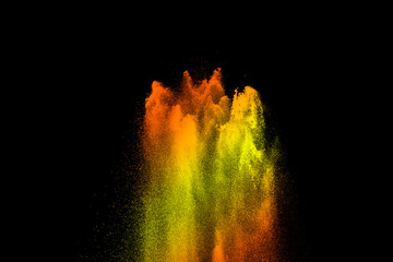 yellow powder explosion on black background. Colored cloud. Color dust explode. Paint Holi