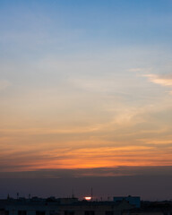 Sunset in Bangkok, Thailand, silhouette of big building in city with dramatic vanilla sky for background.