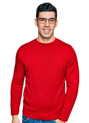 Handsome hispanic man wearing casual clothes and glasses with a happy and cool smile on face. lucky...