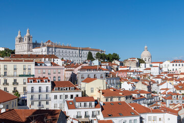 Fototapeta na wymiar View of Alfama neighborhood Lisbon, Portugal with on hill Monastery of São Vicente de Fora and Church of Santa Engrácia (Igreja de Santa Engrácia), originally National Pantheon in background