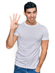 Fototapeta premium Handsome hispanic man wearing casual white t shirt showing and pointing up with fingers number four while smiling confident and happy.