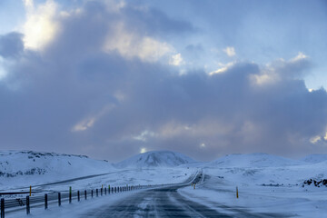 Driver’s perspective view over the almost empty ring road route 1 of Iceland bending through a...