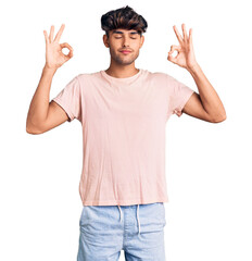 Young hispanic man wearing casual clothes relax and smiling with eyes closed doing meditation gesture with fingers. yoga concept.