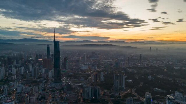 Aerial view time lapse 4k video of Kuala Lumpur city center view during dawn overlooking the city skyline in Federal Territory, Malaysia. 