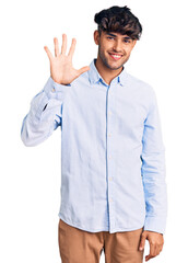 Young hispanic man wearing casual shirt showing and pointing up with fingers number five while smiling confident and happy.