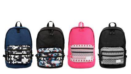 Closeup of four children's schoolbags, isolated on white background.