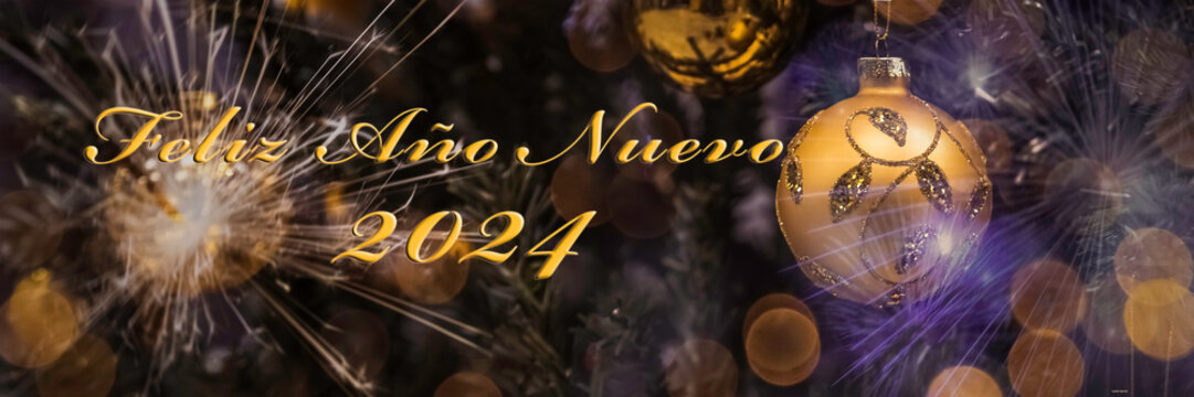 Text "Feliz Ano Nuevo" means "Happy New Year 2024" in Spanish. Blurred background of decorated Christmas tree with big golden ball. Bokeh. Celebration. 1 January. Greeting postcard Spain. Header.
